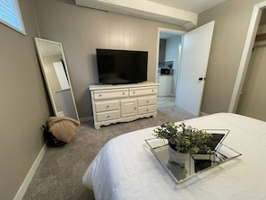Bedroom with queen bed, dresser and closet. 