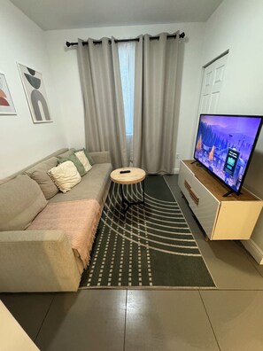 Living Room with a pull-out couch and Smart TV with access to streaming services