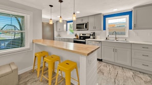Main kitchen with cool island (ambient lighting under the countertop)