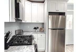 Kitchen with marble leather finish countertops