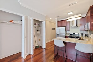 Fully stocked kitchen with microwave, stove, oven, coffee maker, toaster, fridge and freezer.