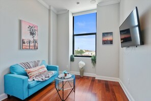 Smartly designed common space with a comfy couch, smart TV, and nice natural light.  All you have to do is log into your favorite streaming services and make it a TV night.