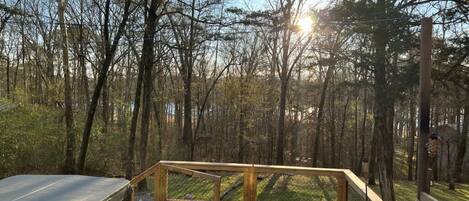 Lake view sunset by the hot tub, secluded by the trees and woods.