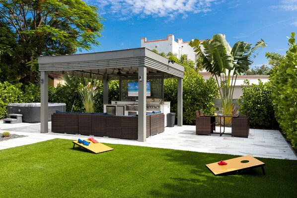 Backyard with grill, mini-fridge, hot tub, TV, and ice-maker!