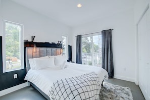 Bedroom with a queen bed, a closet, a private bedroom, and a private balcony!