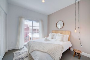 Bedroom with a queen bed, a closet, a private bedroom, and a private balcony!