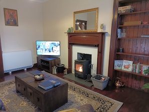 Lounge with smart TV and wood burner.