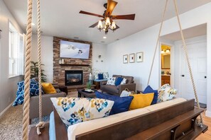 Cozy fireplace, big TV, and plenty of seating to gather around for entertainment!