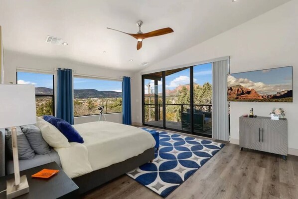Upstairs primary bedroom with private balcony and ensuite bathroom (dual vanities, soaking tub and walk-in shower)