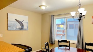 Spacious dining area has breakfast bar with bench seating