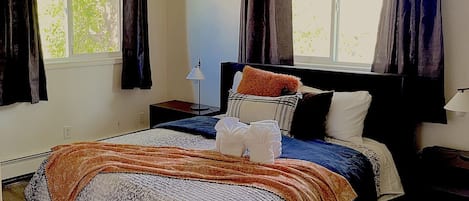 Comfortable queen bed with night stands and lamps + Large windows with black out blinds