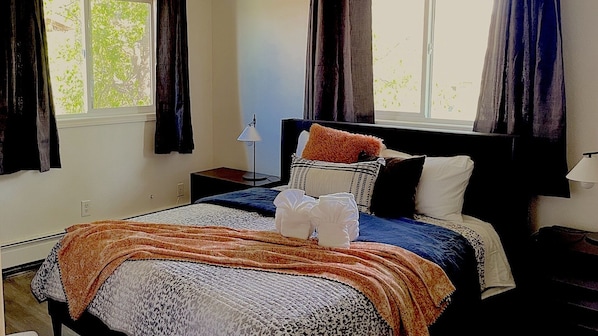 Comfortable queen bed with night stands and lamps + Large windows with black out blinds