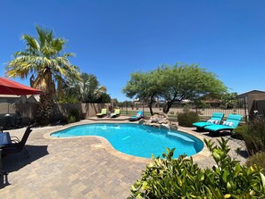 Spacious patio with a private yard and view fence overlooking a quiet park.