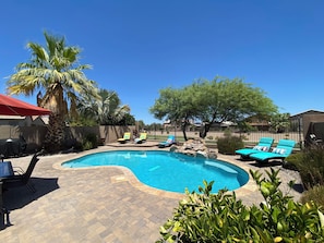 Spacious patio with a private yard and view fence overlooking a quiet park.