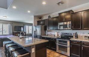 Generous Chef's kitchen with double oven, huge island and granite countertops.