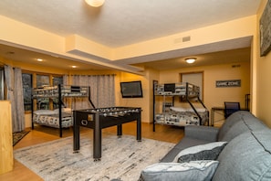 Downstairs bunk room/game room with seating area, Smart TV and foosball table.