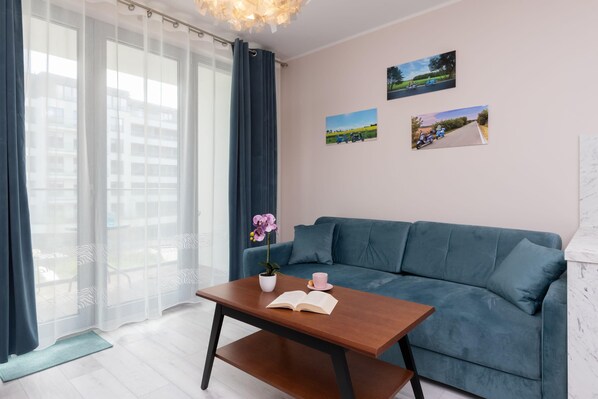 Relax in the stylish living room with a comfortable sofa and modern decor.