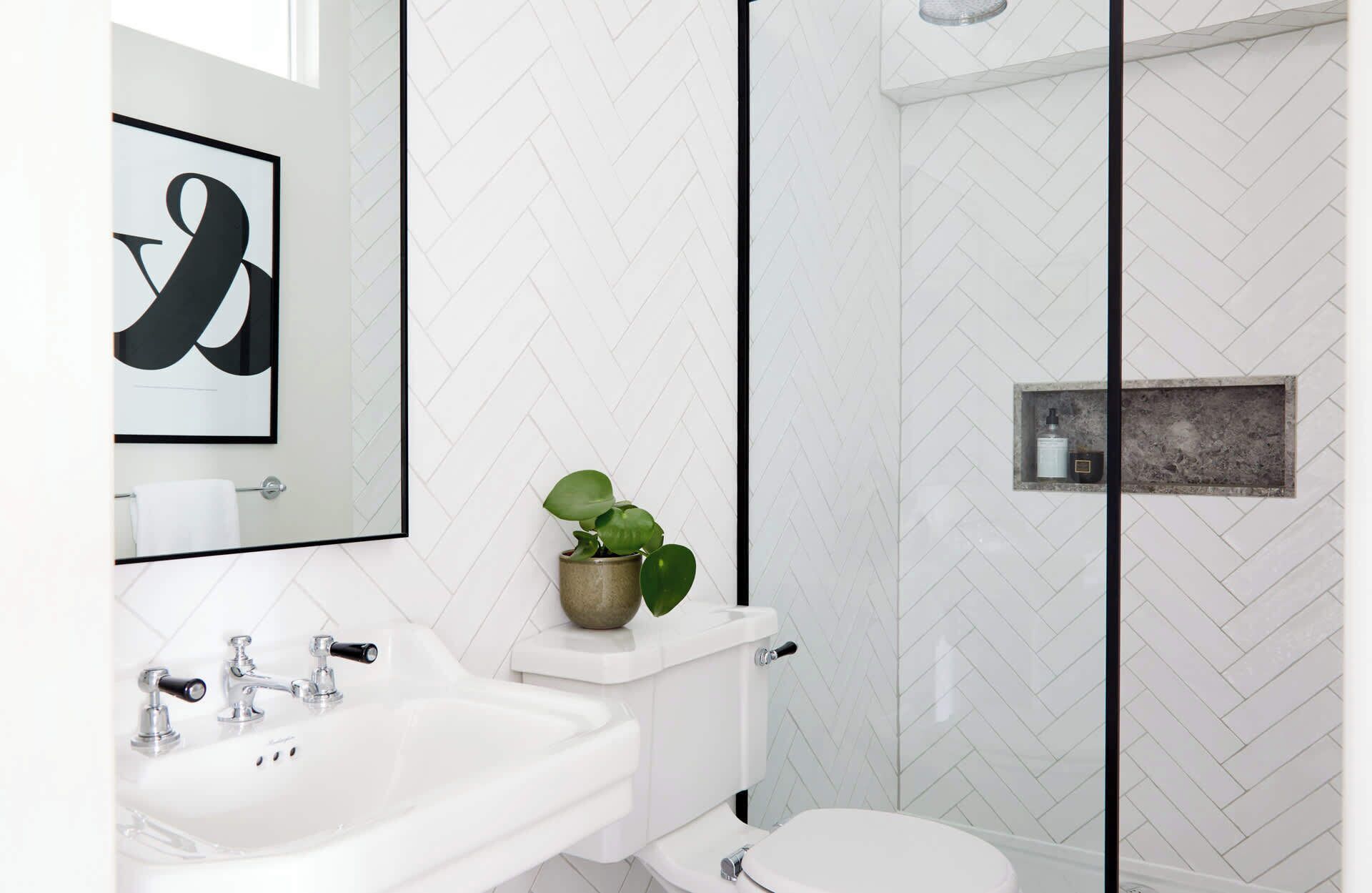 Flat 2 stylish bathroom featuring a sleek glass shower enclosure.