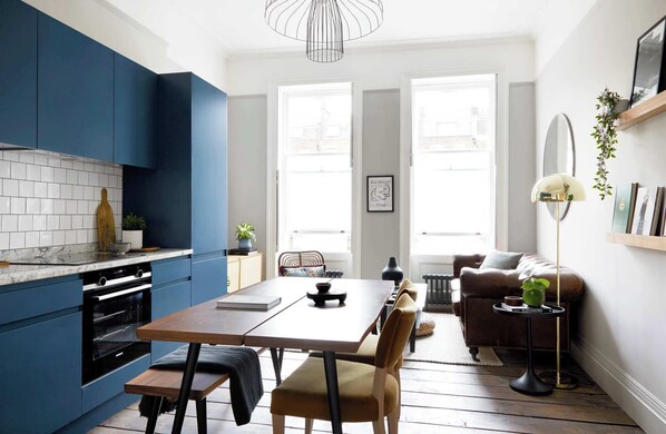 Flat 2 dining table, kitchen, and living area seamlessly blend.