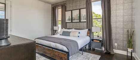 Primary bedroom with King bed, fold out full bed, and smart TV.