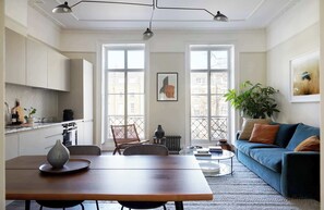 Flat 3 open-plan living area with a large wooden dining table.