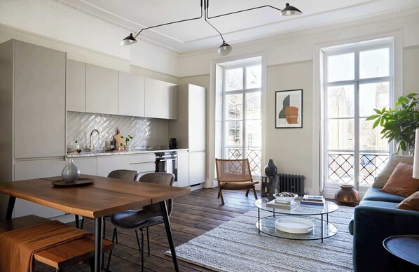 Flat 3 open-plan living area with a large wooden dining table.