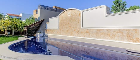 Take a refreshing dip in the sparkling community pool surrounded by lush greenery