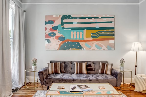 The living room features a sleeper sofa and a ROKU Smart TV.