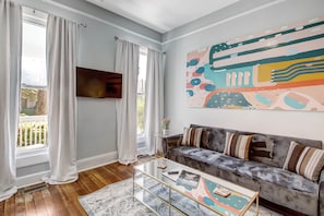 The living room features a sleeper sofa and a ROKU Smart TV.