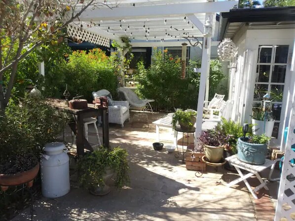 Enjoy our shared lush and sunny backyard with lots of serene sitting areas.