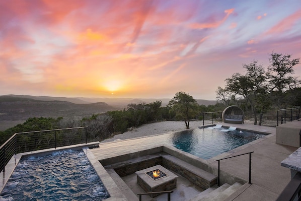 Backyard oasis with stunning sunrises, huge hot tub, and infinity pool overlooking the hills.