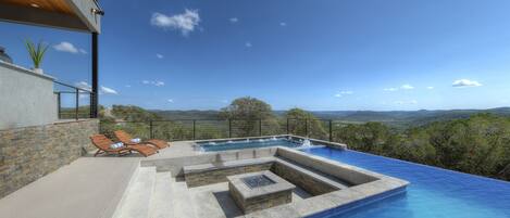 Dream pool! Infinity edge pool, huge 16 person hot tub, a firepit sunk into the middle, and Texas Hill Country views!!