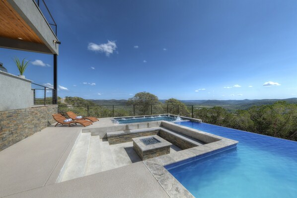 Dream pool! Infinity edge pool, huge 16 person hot tub, a firepit sunk into the middle, and Texas Hill Country views!!