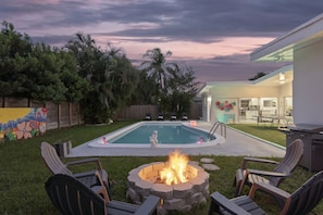 Outdoor area with Fire Pit/ view on pool and neon graffiti wall 
