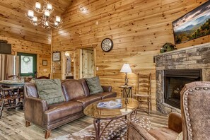 Forest themed living area with 2 walls of windows