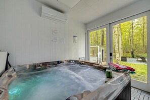 Pocono rental | Hot tub and Sauna room, soak up with the view