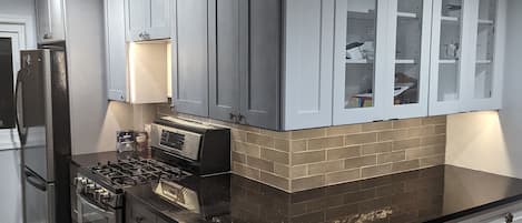 Newly installed kitchen.  Full refrigerator,  stove/oven 