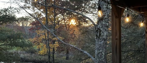 Amazing view from large covered back porch with furniture and grill. 