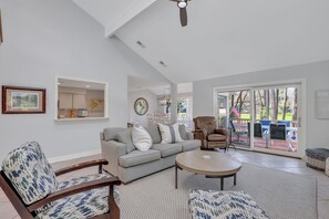 Spacious open floor plan living room with a smart TV and patio access.