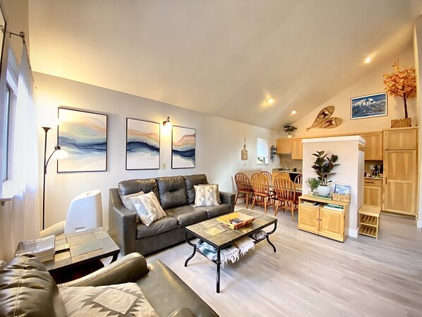 Open concept living room w/ vaulted ceilings. New paint and flooring throughout!