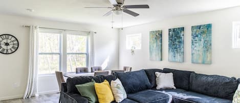 Large, main floor living area with sectional and dining area