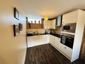 Kitchen incl coffee machine & dishwasher.  Washing machine also in cottage