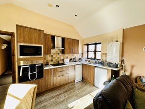 Open plan well equipped kitchen - dishwasher, coffee machine, microwave etc