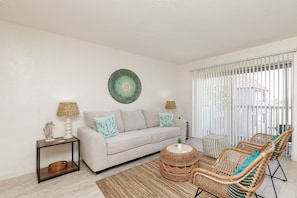 Spacious and cozy living room perfect for relaxation with private balcony