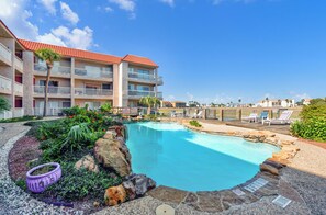 Indulge the canal, water views at Mystic Harbor pool with relaxing loungers