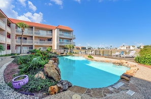 Indulge the canal, water views at Mystic Harbor pool with relaxing loungers