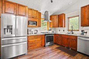 The gorgeous, fully-remodeled kitchen boasts stainless steel appliances, generous cabinet and counter space, a bar/serving area that seats four and windows with breathtaking views located over the sink and stove.