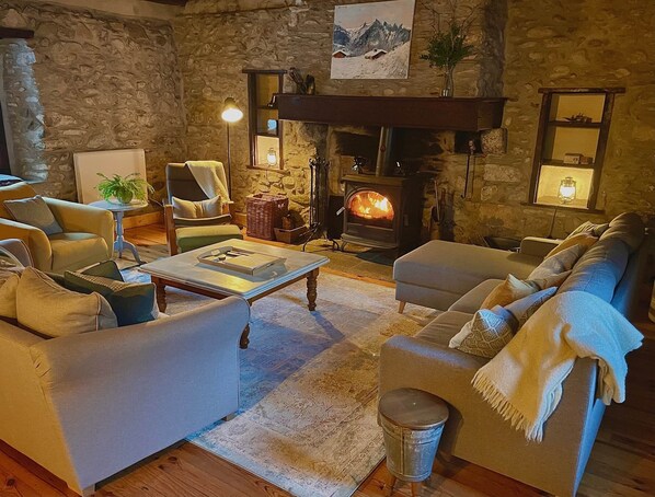 Large comfortable lounge, with ample seating, perfect for a social gathering.