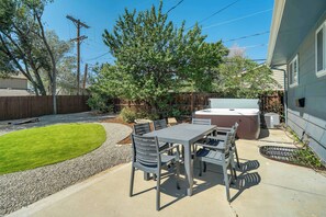 Relax and unwind in the spacious backyard, complete with a dining set and a private hot tub for ultimate outdoor comfort.