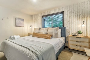 The King Master bedroom is curated just for you! Enjoy the large Smart TV, luxurious bedding, and your own private on-suite bathroom with a shower, toilet, and vanity sink!